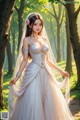 A woman in a wedding dress standing in the woods.